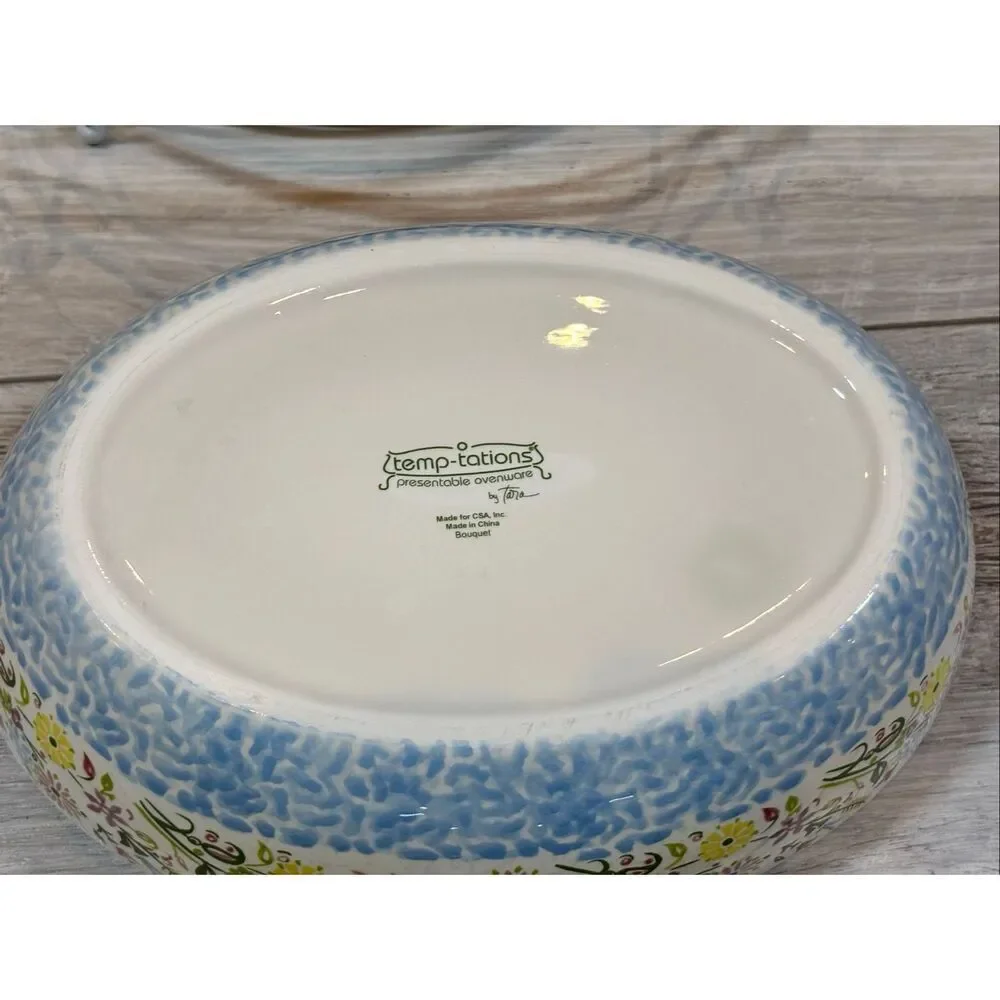 Temp-tations Ovenware by Tara Blue oval covered casserole dish with a metal stan